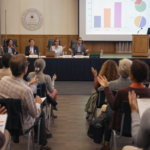 firefly community meeting in a city hall auditorium where residents discuss budgeting proposa 241454