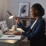 firefly professional working remotely at a home office desk with laptop, video meeting on scr 241454